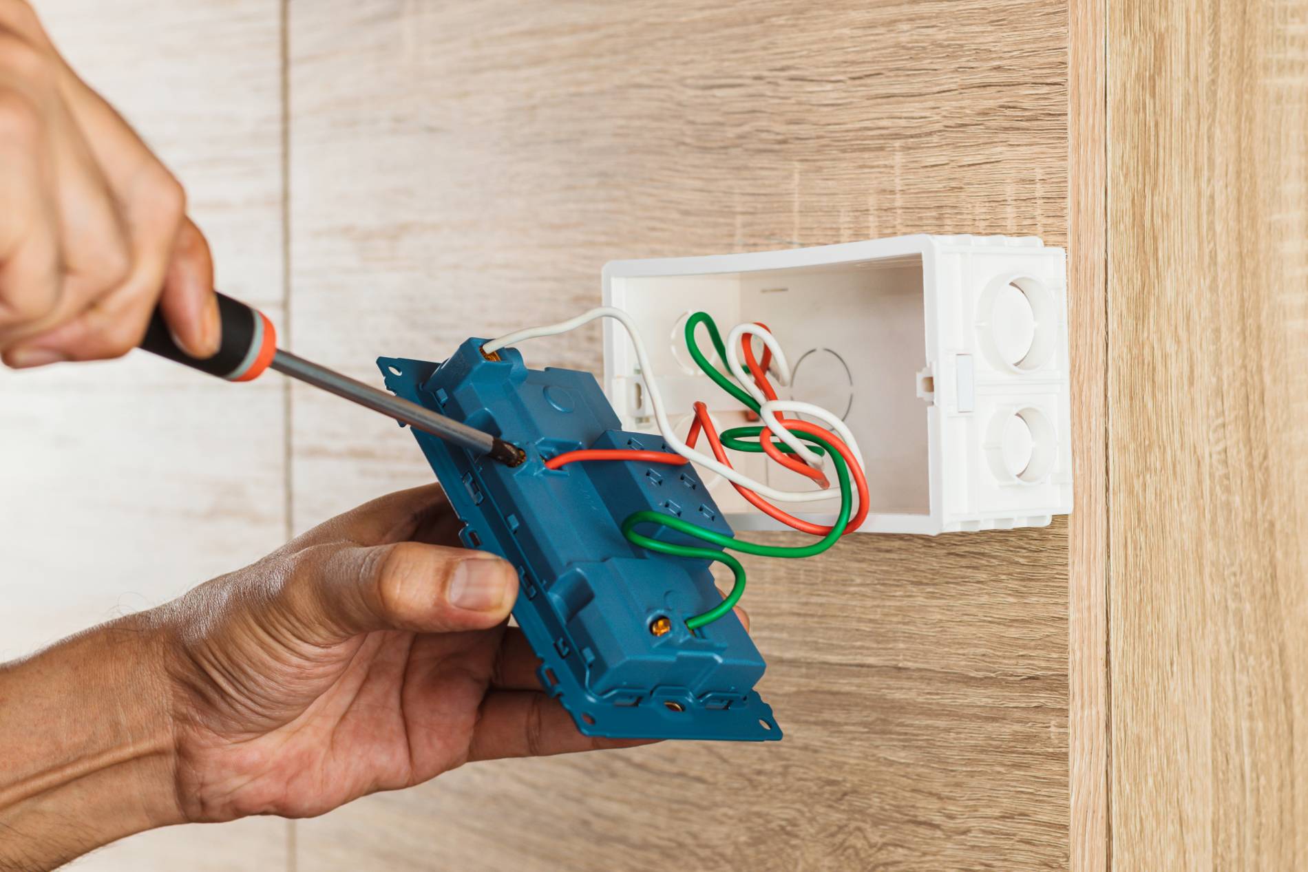 hand-electrician-is-using-screwdriver-attach-wires-socket_1900x1267